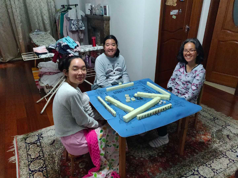 Gloria and her two children play mahjong to pass the time and grow closer as a family during online learning